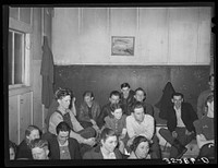 Farmers at pie supper listening to the auctioneer. Muskogee County, Oklahoma. See general caption number 24 by Russell Lee