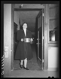 Wife of Jaycee member bringing food to the buffet supper at the high school. Eufaula, Oklahoma. See general caption 25 by Russell Lee