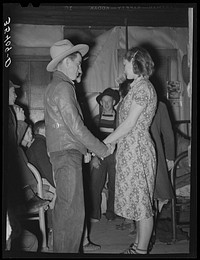 Farm boy and girl playing "Pleased or displeased" at play party in McIntosh County, Oklahoma. See general caption 26 by Russell Lee