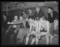 High school coach giving last minute instructions to substitute who is going into the game. Basketball game, Eufaula, Oklahoma by Russell Lee