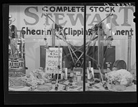 Hardware store window in San Angelo, Texas, which claims to be the largest wool marketing center in the west by Russell Lee