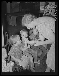 [Untitled photo, possibly related to: Children receiving cod liver oil and grapefruit at the WPA (Work Projects Administration) nursery school at the Agua Fria migratory labor camp. Arizona] by Russell Lee