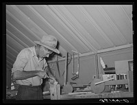 Migratory agricultural laborer making toys for the WPA (Work Projects Administration) nursery school at the Agua Fria migratory labor camp, Arizona. Farm work was slack and this man volunteered to make and repair nursery supplies during his idle time-- no pay being received by Russell Lee