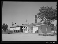 Dairy barn which contains milking stalls, cooling equipment, cream separator and cold storage locker. Casa Grande Valley Farms, Pinal County, Arizona by Russell Lee