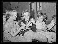 Young boys singing at Sunday school at the community house at the Casa Grande Valley Farms. Pinal County, Arizona by Russell Lee