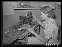 Mrs. Jack Whinery making a fly swatter. These homesteaders never buy anything that they can make at home. Pie Town, New Mexico by Russell Lee