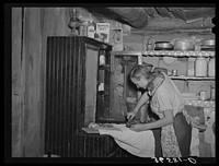 Mrs. Faro Caudill ironing. Pie Town, New Mexico. Mrs. Caudill was born and finished high school at Sweetwater, Texas, before coming with her husband to Pie Town, New Mexico, to homestead by Russell Lee