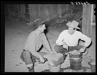 Farmers freezing ice cream. Pie Town, New Mexico. There is no ice in the town. Two or three farmers have built ice storage houses of wooden blocks, packing the ice in sawdust. When someone makes the thirty or forty mile trip for ice, several families get together for an ice cream party by Russell Lee