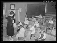 School opens with prayer. This is the private school in the Farm Bureau building. Pie Town, New Mexico by Russell Lee