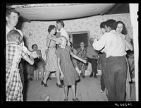 The broom dance at the square dance. Pie Town, New Mexico. The extra girl or man dances around with a broom for a partner. Then drops broom loudly; everyone must change partners and the one left out in the exchange must then dance with the broom by Russell Lee