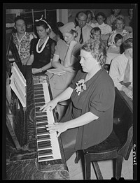 [Untitled photo, possibly related to: Pianist at community sing. Pie Town, New Mexico. She and her husband were one of the first homesteaders] by Russell Lee