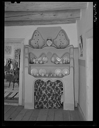 Homemade adobe cupboard in Spanish-American farm house. Chamisal, New Mexico by Russell Lee