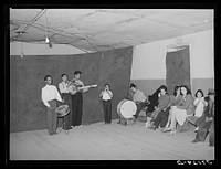 Orchestra and audience at Spanish-American traveling show. Penasco, New Mexico by Russell Lee