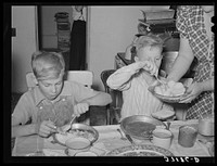 Children of Mormon farmer at dinner. Box Elder County, Utah by Russell Lee