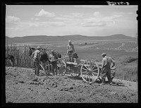 Members of FSA (Farm Security Administration) cooperative manure spreader placing manure on farmland. Box Elder County, Utah by Russell Lee