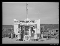 Filling station is only building of modern design in the Spanish-American village of Penasco, New Mexico by Russell Lee