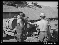 Pouring gasoline into tank of converted automobile which supplies power for FSA (Farm Security Administration) cooperative orchard sprayer. Cache County, Utah by Russell Lee