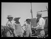 Mr. Thayne, FSA (Farm Security Administration) cooperative specialist, talking to the three Ericson brothers. Box Elder County, Utah by Russell Lee