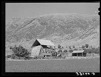 Hay barn on farm at foot of Wasatch Mountains. Box Elder County, Utah by Russell Lee