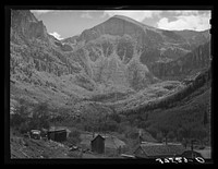 [Untitled photo, possibly related to: End of mountain valley near Telluride, Colorado, showing road up to mine and Bridal Veil Falls] by Russell Lee