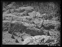 Rocks in the Uncompahgre River Valley, Ouray County, Colorado. Water from this river is used for irrigation and gold mining and milling operations by Russell Lee