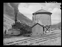[Untitled photo, possibly related to: Narrow gauge railway yards, train and water tank at Telluride, Colorado] by Russell Lee