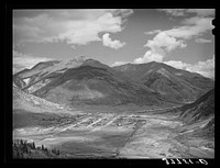 [Untitled photo, possibly related to: Silverton, Colorado lies in a valley at 9400 feet elevation. This has been a center for mining and milling operations and the tailing-choked Animas River can be seen at left] by Russell Lee