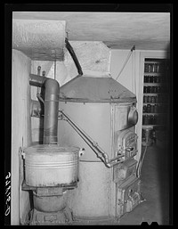 Many of the farmers living in Santa Clara, Utah, have central heating plants in their homes. This is one of the home furnaces by Russell Lee