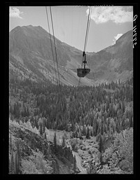 [Untitled photo, possibly related to: Aerial tramway leaving from mine in distance to the mill. Because of the inaccessability of this country by ordinary transportation methods, these aerial trams are the most efficient means of carrying ore from mine to mill. San Juan County, Colorado] by Russell Lee