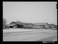 Truck and tractor repair storage shops are centrally located at the Earl Fruit Company ranch. Kern County, California by Russell Lee