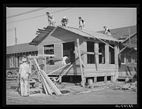 Men working on office building of replacement cantonment of coast artillery. San Diego, California by Russell Lee