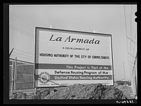 Sign at U.S.H.A. project under construction. Corpus Christi, Texas. This project will provide housing for two hundred forty-nine married enlisted men and civilian employees at the naval air training base. Corpus Christi, Texas by Russell Lee