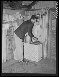 Farmer washing his hands. Placer County, California. This man is from Oklahoma; he came to California first in '35, went back to Oklahoma in '39. Then returned to California. He and his family picked cotton around Bakersfield. He rented his farm in Placer County first and is now buying it. It has thirty-eight acres,  twelve in plums and peaches by Russell Lee