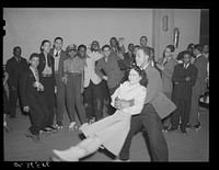  swinging his girl on roller skates. Savoy Ballroom, Chicago, Illinois by Russell Lee