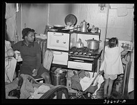 Kitchen in crowded  apartment. Chicago, Illinois by Russell Lee