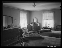 [Untitled photo, possibly related to: Master bedroom in home. Chicago, Illinois] by Russell Lee
