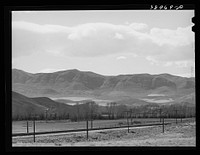 Fields extending into the mountains. Henefer, Utah. Mormon farmers in this section not only practice irrigation but take advantage of as much of all natural runoff from the mountains as possible by Russell Lee