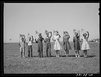 Flag drill for entertainment at end of school term at the FSA (Farm Security Administration) camp for farm workers. Caldwell, Idaho by Russell Lee