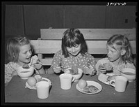 Schoolchildren eating lunch at the FSA (Farm Security Administration) farm workers' camp. Caldwell, Idaho by Russell Lee