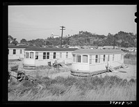 Streetcars which have been converted into dwellings. These rent for twenty-five dollars per month. They are equipped with electricity, running water and bathrooms. San Diego, California by Russell Lee