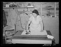 Wife of migratory farm worker ironing in shelter at the FSA (Farm Security Administration) labor camp. Caldwell, Idaho by Russell Lee