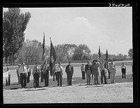 Members of the American Legion and Boy Scouts stand at attention while Chief Justice Stone delivered the oath of allegiance over the radio. This was part of the nationwide program on the Fourth of July and in Vale, Oregon, the baseball game was interrrupted for those present to hear the speech of President Roosevelt and Chief Justice Stone by Russell Lee
