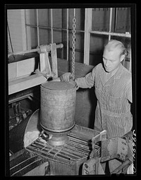 [Untitled photo, possibly related to: Dumping milk into container where it will be weighted and the weight automatically recorded at the Dairymen's Cooperative Creamery. Caldwell Canyon, Idaho] by Russell Lee