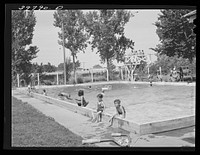 Swimming pool at Athena, Oregon. This pool is near the FSA (Farm Security Administration) migratory labor camp mobile unit and the children of the camp swim and receive swimming lessons three days a week by Russell Lee
