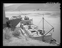 Loading bulk wheat into barge which will carry it down the Columbia River from Port Kelly to Portland. Walla Walla County, Washington by Russell Lee
