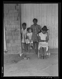 [Untitled photo, possibly related to: Some of the people living in an old garage converted into a dwelling. Outskirts of Graham, Alamance County, North Carolina]. Sourced from the Library of Congress.
