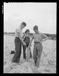 [Untitled photo, possibly related to: Tenant farmer and part of his family in field ready for tobacco planting. Nine miles north of Danville, Pittsylvania County, Virginia]. Sourced from the Library of Congress.