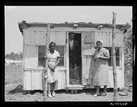 Burdell White, FSA (Farm Security Administration) client, his wife and daughter standing beside their new chicken coop obtained through FSA aid. Sourced from the Library of Congress.