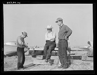 Deal Island fisherman. Man on left is opening an oyster. Eastern Shore, Maryland. Sourced from the Library of Congress.
