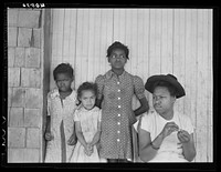 [Untitled photo, possibly related to: Some of the people living in an old garage converted into a dwelling. Outskirts of Graham, Alamance County, North Carolina]. Sourced from the Library of Congress.